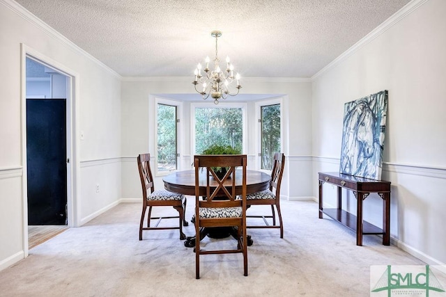 dining room with ornamental molding, a textured ceiling, light carpet, and a notable chandelier