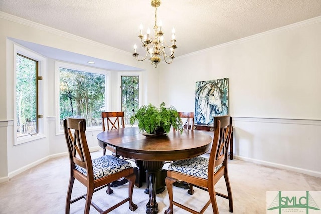 dining room with light carpet, a notable chandelier, ornamental molding, and a textured ceiling