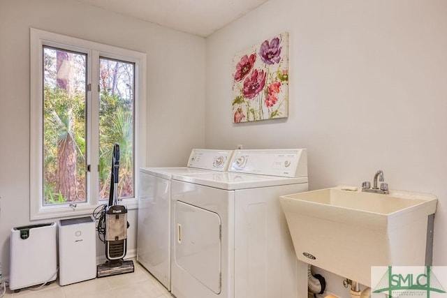 laundry area with washing machine and dryer, sink, and light tile patterned flooring