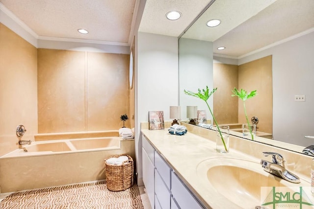 bathroom with crown molding, vanity, a textured ceiling, tile patterned floors, and a tub