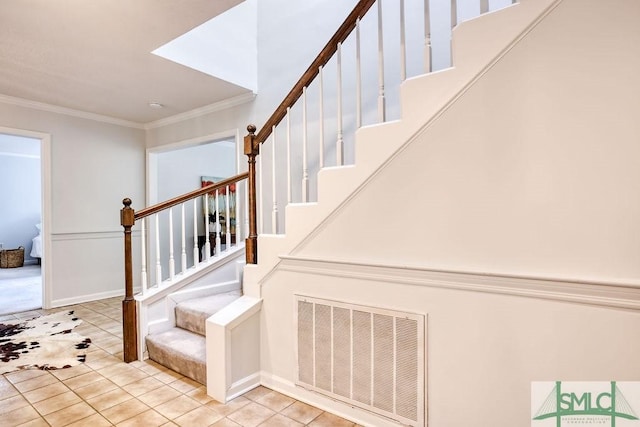 stairs featuring crown molding and tile patterned flooring