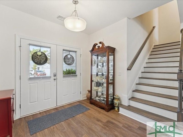 foyer featuring hardwood / wood-style floors and french doors