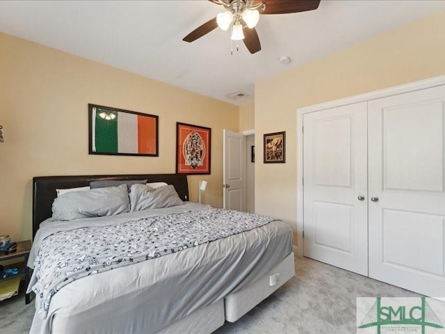 bedroom featuring light carpet, ceiling fan, and a closet