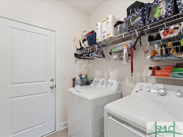 clothes washing area with washer and clothes dryer