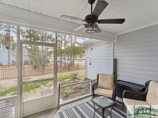 sunroom / solarium featuring ceiling fan and a wealth of natural light