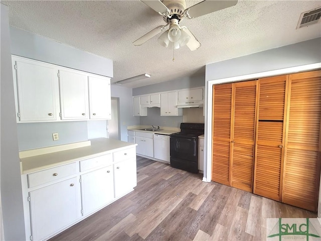 kitchen featuring white cabinetry, white dishwasher, black electric range, and light hardwood / wood-style flooring