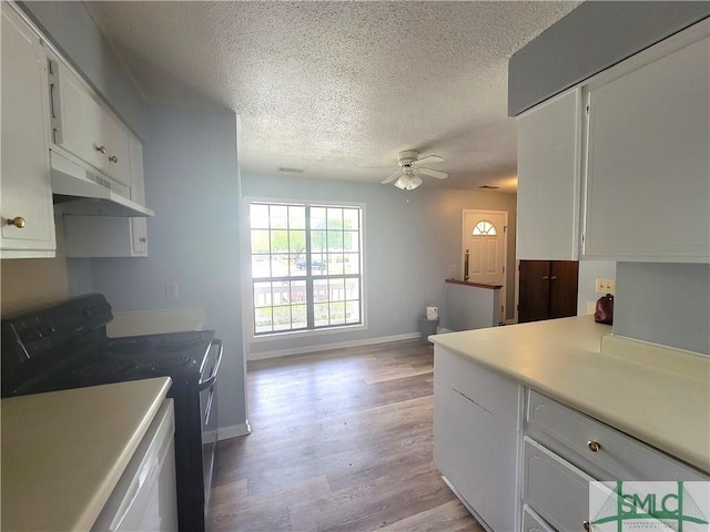 kitchen featuring black electric range oven, ceiling fan, white cabinetry, a textured ceiling, and light wood-type flooring