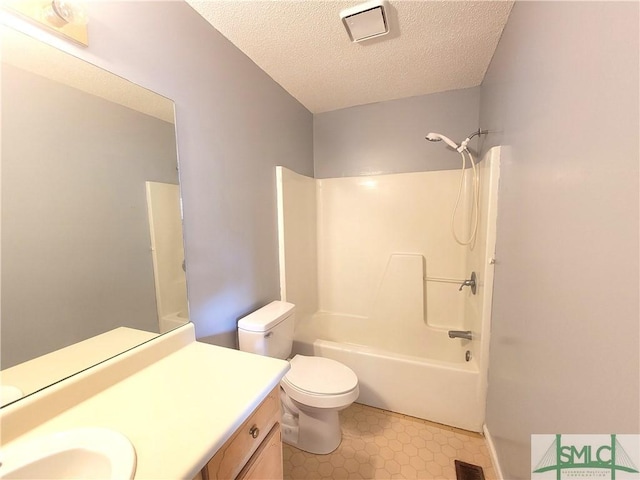 full bathroom featuring tile patterned flooring, vanity,  shower combination, toilet, and a textured ceiling