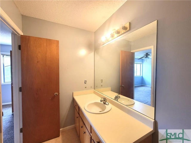 bathroom with vanity and a textured ceiling