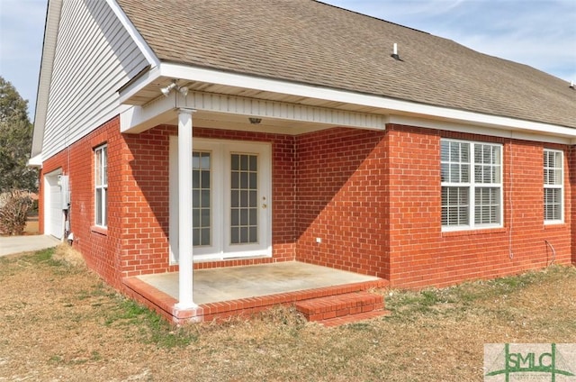 rear view of house with a yard and a garage