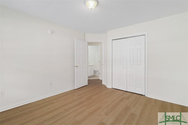 unfurnished bedroom with a closet and light hardwood / wood-style flooring