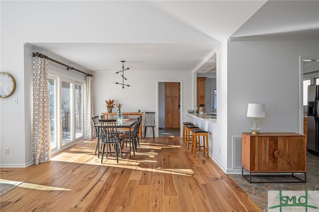 dining space with crown molding and hardwood / wood-style floors