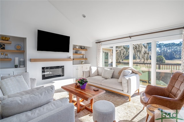 living room with plenty of natural light and high vaulted ceiling