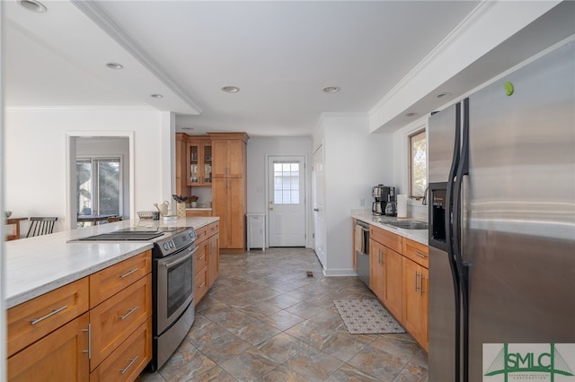 kitchen featuring stainless steel appliances, ornamental molding, and sink