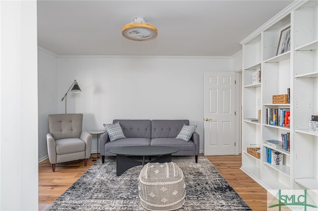 living room with crown molding and hardwood / wood-style flooring