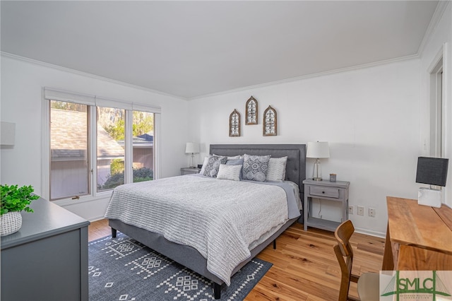 bedroom with ornamental molding and hardwood / wood-style floors