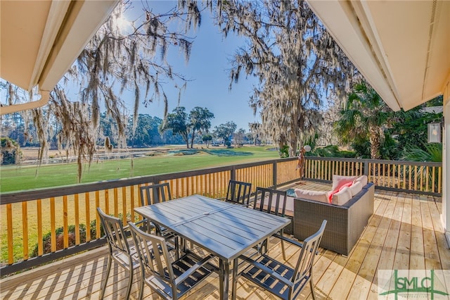 wooden deck featuring outdoor lounge area and a yard