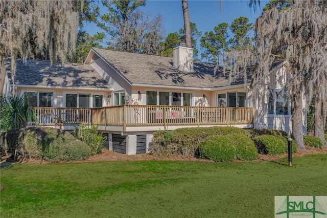 rear view of property with a yard and a deck