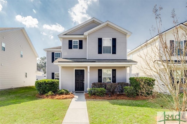 view of property with covered porch and a front yard