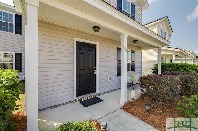 doorway to property featuring covered porch