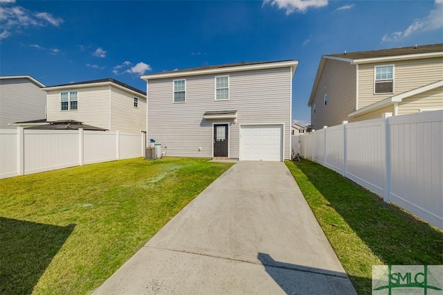 back of house featuring a yard, concrete driveway, an attached garage, central AC, and a fenced backyard