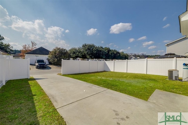 view of yard with a fenced backyard and central AC unit