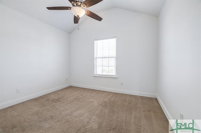 carpeted empty room featuring lofted ceiling, baseboards, and a ceiling fan