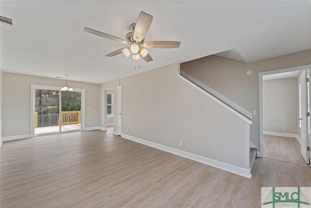 unfurnished living room with ceiling fan and light hardwood / wood-style flooring