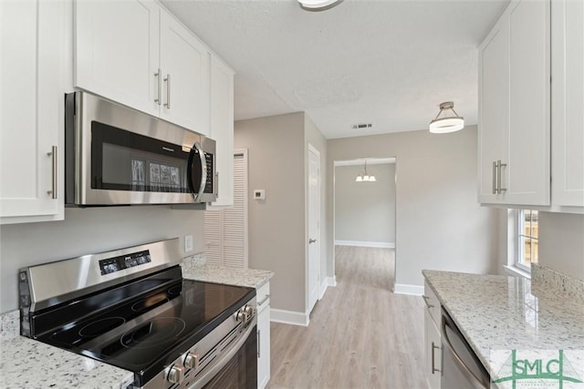 kitchen with white cabinetry and appliances with stainless steel finishes