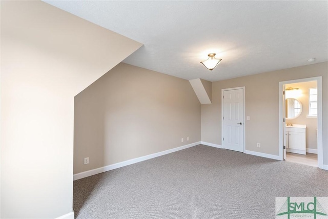 bonus room featuring light carpet