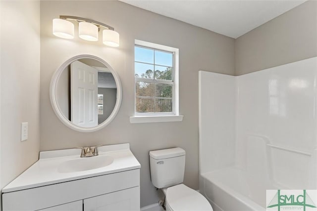 full bathroom featuring vanity, bathtub / shower combination, and toilet