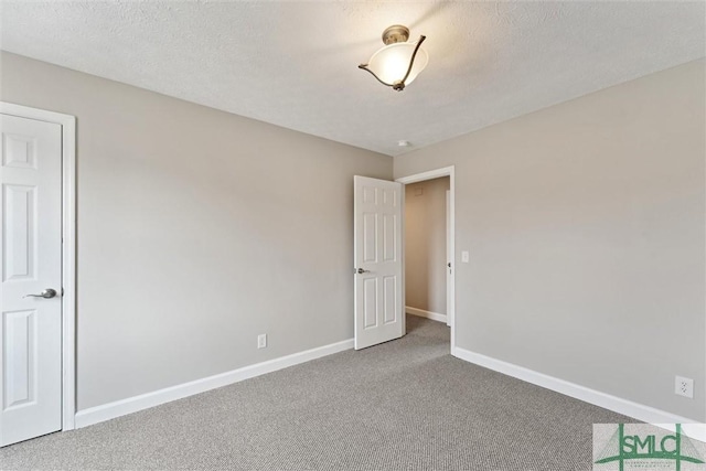 spare room with carpet floors and a textured ceiling