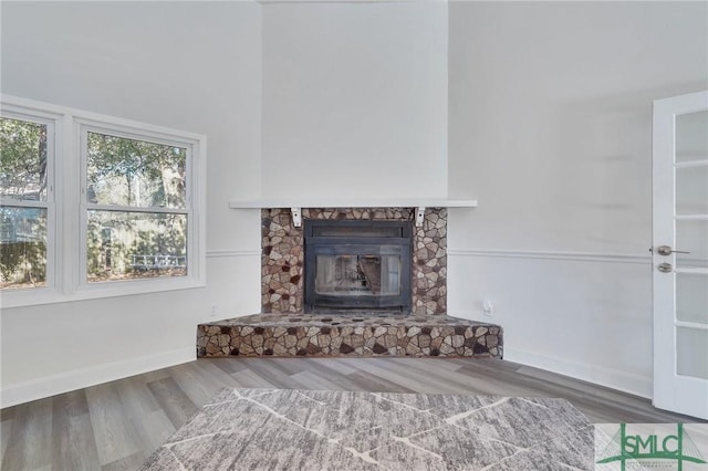 unfurnished living room featuring a fireplace and hardwood / wood-style floors