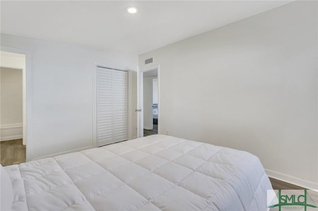 bedroom featuring hardwood / wood-style flooring and a closet