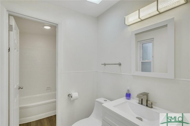 bathroom with vanity, toilet, and hardwood / wood-style floors