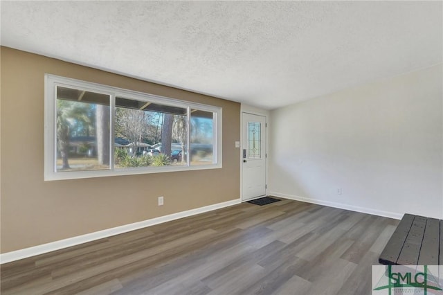 foyer with hardwood / wood-style flooring and a textured ceiling