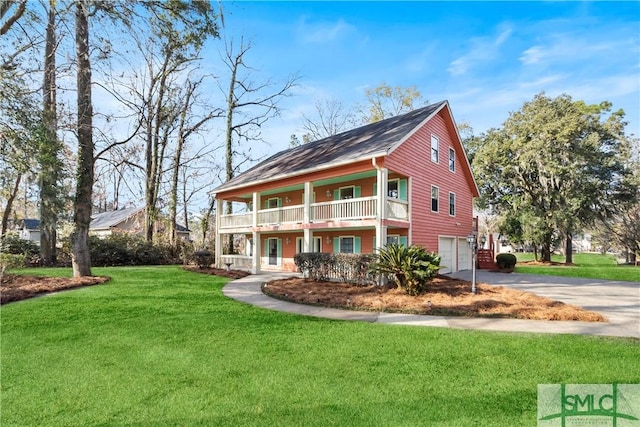 view of front facade featuring a front lawn, an attached garage, a balcony, and driveway