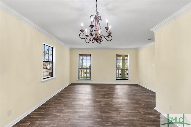 spare room with dark wood-style floors, visible vents, baseboards, crown molding, and a chandelier