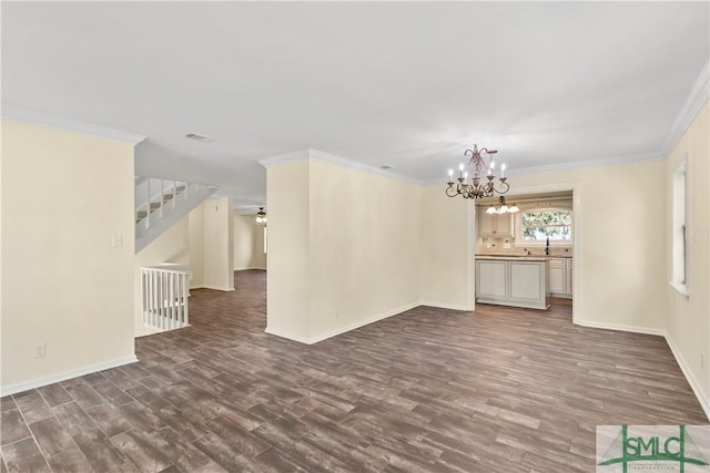 unfurnished living room with dark wood-style floors, crown molding, and baseboards