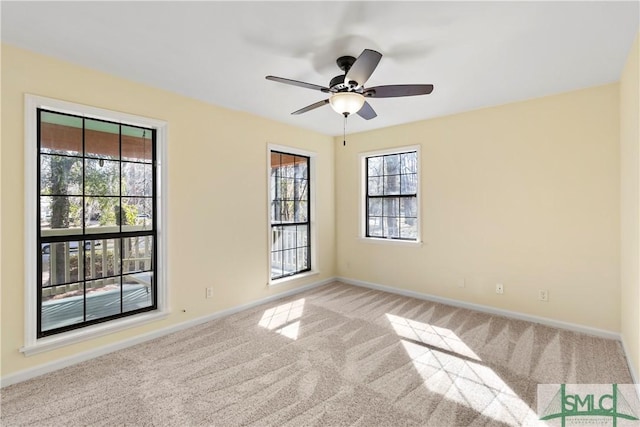 empty room with light colored carpet and ceiling fan