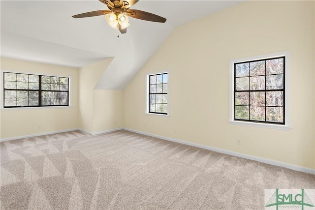 additional living space featuring carpet flooring, baseboards, lofted ceiling, and a ceiling fan