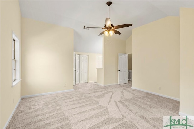 unfurnished room with ceiling fan, high vaulted ceiling, and light carpet