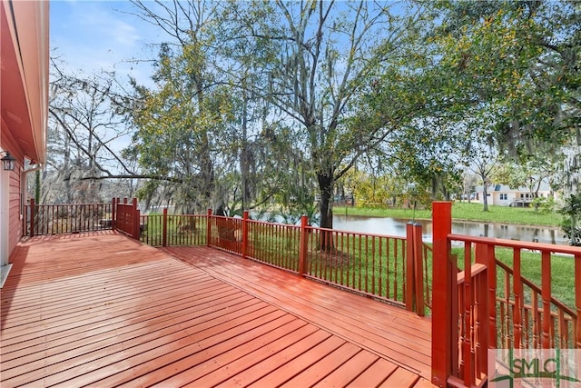 wooden terrace featuring a water view