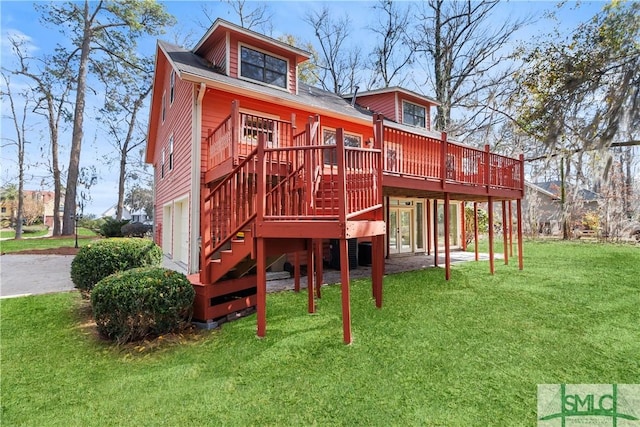 exterior space with a deck, a yard, and stairs