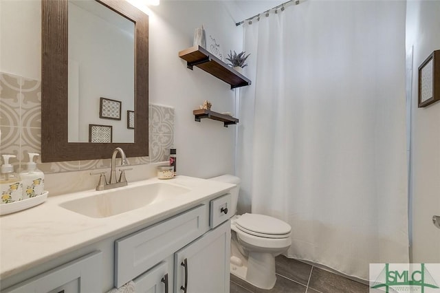 bathroom with vanity, tile patterned flooring, and toilet