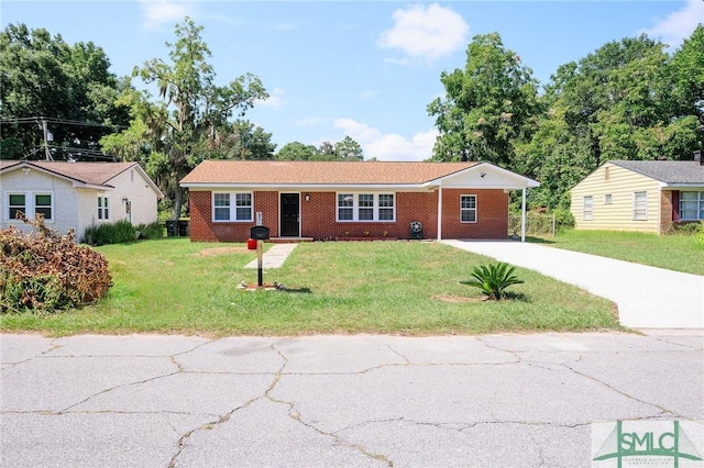 ranch-style home with a carport and a front yard