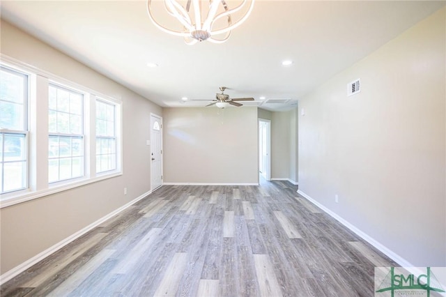 empty room with hardwood / wood-style flooring and ceiling fan