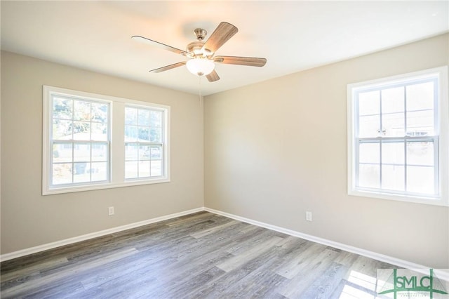 spare room with hardwood / wood-style flooring and ceiling fan