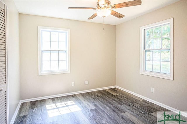 spare room featuring ceiling fan and dark hardwood / wood-style flooring