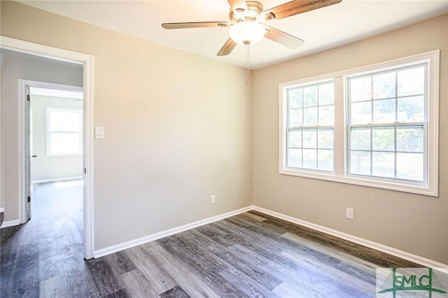 spare room featuring dark wood-type flooring and ceiling fan